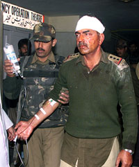 An injured Indian Border Security officer is helped by a colleague