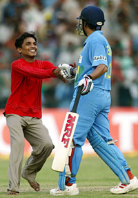 A fan congratulates Sachin Tendulkar on his century