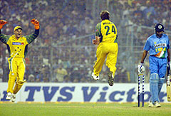 Australias Brad Williams jumps to celebrate the dismissal of Indian batsman VVS Laxman with wicketkeeper Adam Gilchrist