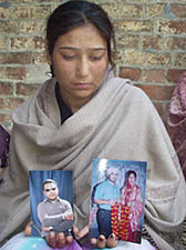 Geeta, Jasbir’s widow, shows old photographs at her in-laws’ house at Jahankhelan village in Hoshiarpur district on Wednesday.