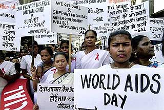 Sex workers carry placards as they take part in a demonstration at Kamathipura in Mumbai