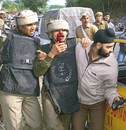 Policemen help their injured colleague during a gunbattle in Sidhra, 9 km from Jammu, on Sunday.