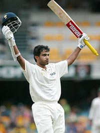 Indian captain Sourav Ganguly raises his bat after reaching his century on the first innings of the first Test between India and Australia at the Brisbane Cricket Ground on Sunday