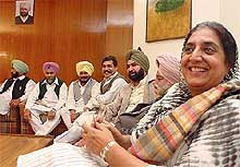 Ms Rajinder Kaur Bhattal smiles as she chalks out a strategy with her supporters