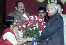 Prime Minister Atal Bihari Vajpayee is presented a bouquet by BJP President Venkaiah Naidu and Parliamentary Affairs Minister Sushma Swaraj