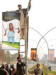Workers hang banners in Pakistans capital Islamabad on Monday in preparation for the upcoming SAARC summit to be held from January 4-6.