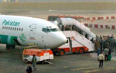 Passengers get down from a Pakistan International Airlines plane in New Delhi on Thursday. 