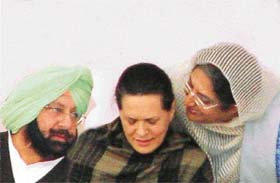 Chief Minister Amarinder Singh and Ms Rajinder Kaur Bhattal vie with each other to get Ms Sonia Gandhis attention at a rally in Bathinda