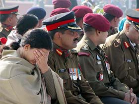 Urmila Ghildiyal, widow of Major Atul Kumar Ghildiyal, tries to control herself at the gallantry award presentation function during the Army Day parade in New Delhi