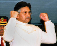 Pakistan President Pervez Musharraf raises his fists after addressing a joint session of Parliament in Islamabad on Saturday.
