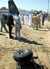 United Arab Emirates rescue workers look at the wreckage of an Iranian Kish Airlines plane which crashed just before landing 