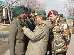 The Chief of the Army Staff, Gen N.C. Vij, presents a gallantry award to a jawan in Srinagar