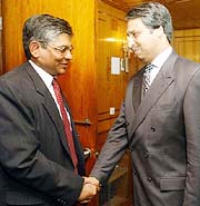 Pakistans Director General for South Asia Jilani Abbas Jilani greets Indias Joint Secretary of External Affairs Arun Singh at the Foreign Ministry in Islamabad