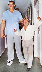 7-foot-plus Dalip towers over a man of average height in The Tribune office on Monday