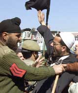 A policeman tries to stop a mourner during an Ashoora procession 