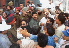 Policemen try to control the protesters during the encroachment clearing operation next to a temple in Purana Bazar locality in Ludhiana