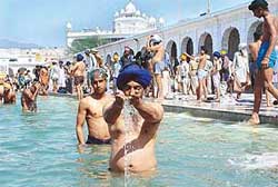 Devotees take a bath at Takht Kesgarh Sahib during the Hola Mohalla celebrations at Anandpur Sahib