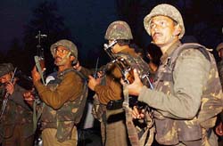 BSF personnel take up positions outside the Srinagar office of the Press Information Bureau which was stormed by militants at Residency Road on Tuesday evening.