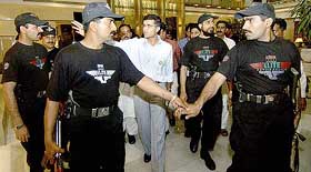Flanked by Pakistani security personnel, Indian cricket captain Sourav Ganguly arrives for a press conference in Lahore