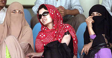 Pakistani women watch a warm-up match between India and Pakistan A in Lahore on Thursday.  India and Pakistan kicked off their cricket series, being played after a gap of 15 years, with the warm-up match in Lahore which India lost by six wickets.