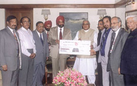 Prime Minister Atal Behari Vajpayee receiving a cheque of Rs 2 crore from S. S. Kohli, CMD of Punjab National Bank, for the Prime Minister’s Relief Fund. Other senior officials of the bank are also seen in the picture.