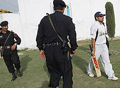Pakistani policemen escort Sachin Tendulkar as he arrives for a training session in Peshawar on Thursday ahead of the third One-Day International between India and Pakistan