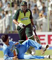 Saurav Ganguly falls as he fails to stop a shot from Yasir Hameed as Pakistan captain Inzamam-ul-Haq takes a run in the third One-Day International between India and Pakistan in Peshawar 