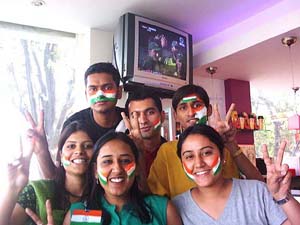 Cricket fans flash victory signs during India's fifth and final match against Pakistan, in Patiala
