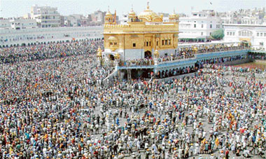 Devotees from far-flung areas, including abroad, participate in the kar seva of the sarovar (holy tank) at the Golden Temple complex in Amritsar on Thursday. 