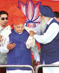 Mr Parkash Singh Badal presents a shawl to Prime Minister Atal Bihari Vajpayee at a public meeting in Amritsar on Friday.