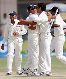 Indias captain Rahul Dravid celebrates with teammate Irfan Pathan after winning the first Test match against Pakistan in Multan