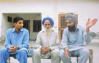Labh Singh, who has tended Tohra’s fields for 50 years, sits in front of the house, which G.S. Tohra built for his family, along with his sons at Tohra village.