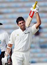 Yuvraj Singh raises his bat after scoring a century 