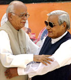 Prime Minister Atal Bihari Vajpayee and Deputy Prime Minister L.K. Advani about to hug each other during an election campaign rally 