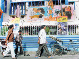 Passers-by glance at obscene posters in Ludhiana on Monday