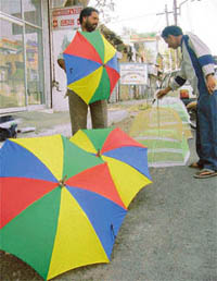 Colourful umbrellas being sold on streets