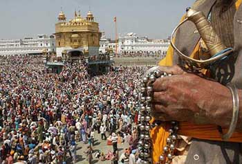 Thousands of devotees perform the second round of Kar seva while cleansing one fourth portion of the Amrit Sarovar at the Golden Temple in Amritsar on Monday.