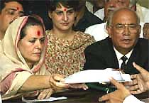 Sonia Gandhi (left), President of the Congress party, files her nomination papers as her daughter Priyanka Vadra (centre) looks on in Rae Bareli 
