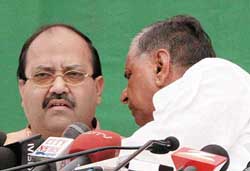 Samajwadi Party President and Uttar Pradesh Chief Minister Mulayam Singh Yadav (right) has a word with party general secretary Amar Singh during a press conference at the party office in Lucknow on Friday. 