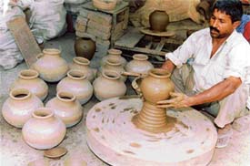 Prem Chand works on a potter’s wheel at Qilla Mohalla