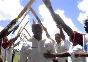 West Indies captain Brian Lara walks under an arch of bats as team-mates congratulate him on his record-breaking 385 on the third day of the fourth & final Test against England at Antigua Recreation Ground, St. John’s, on Monday. Lara later became the first player in history to score 400 runs in Test cricket.