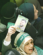 A Palestinian woman holds a picture of Hamas leader Abdel Aziz al-Rantissi, during his funeral in Gaza on Sunday.