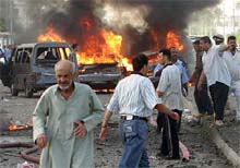 Rescuers rush to the scene of one of the car bomb explosions in the southern Iraq city 