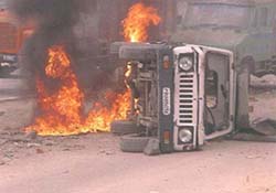 A Punjab police vehicle set on fire by an agitating mob in Jalandhar on Thursday.