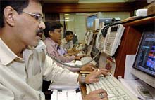 A stock dealer checks his computer monitor as Sensex fell by more than 213 points at BSE on Tuesday after exit polls in India’s general elections indicated a strong possibility of a hung Parliament.