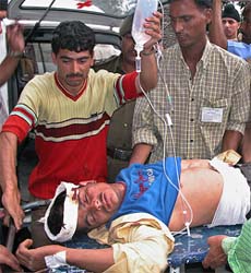 A Kashmiri man is rushed to a hospital in Jammu after a huge explosion at an election campaign rally in Doda district