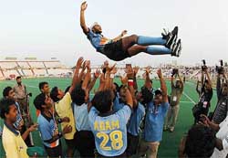 Indian players toss teammate Sandeep Singh after winning the 5th Junior Asia Cup Hockey Tournament in Karachi on Thursday. India beat Pakistan 5-2 in the final.
