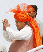 Prime Minister Atal Bihari Vajpayee acknowledges greetings of people at an election rally in Jhajjar on Sunday. 