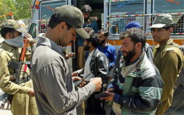 Policemen check I-cards of bus passengers on the eve of elections in Anantnag, 55 km south of Srinagar