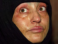 A woman weeps after a gunbattle at her house in Srinagar